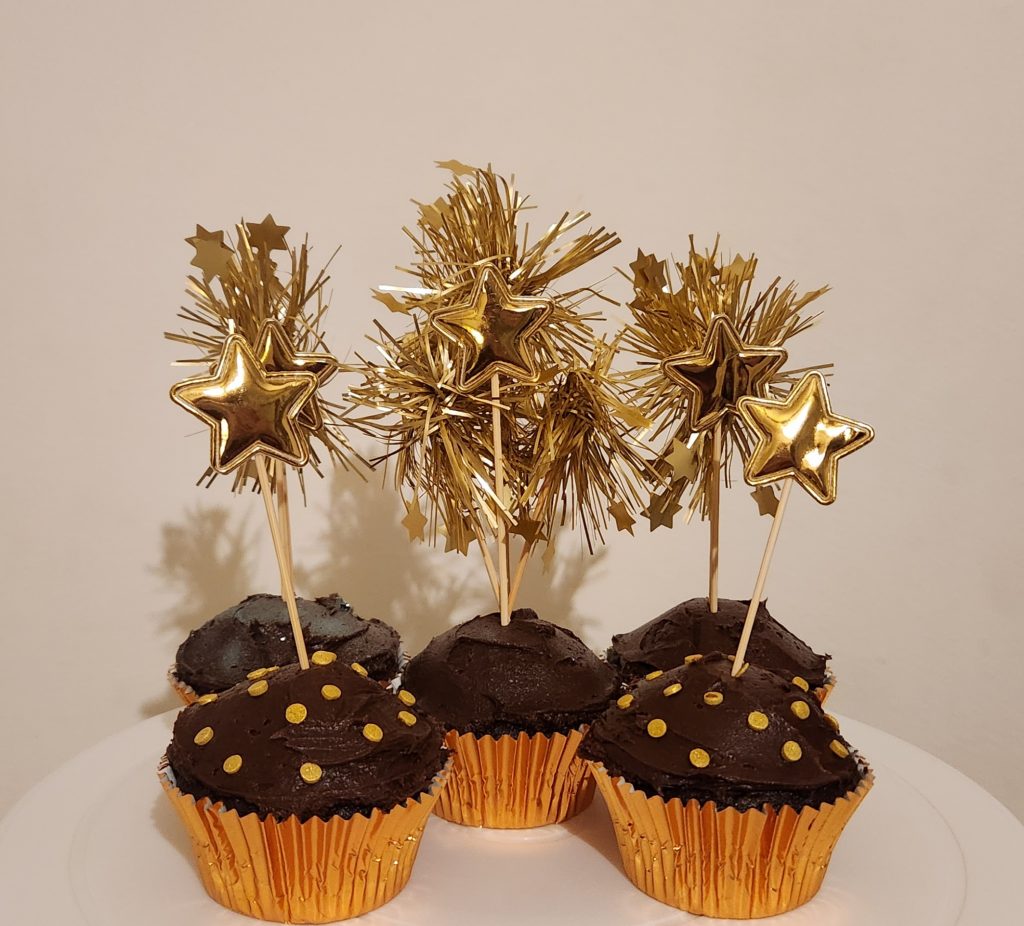 Chocolate cupcakes with golden firework cupcake toppers and golden star cupcake toppers
