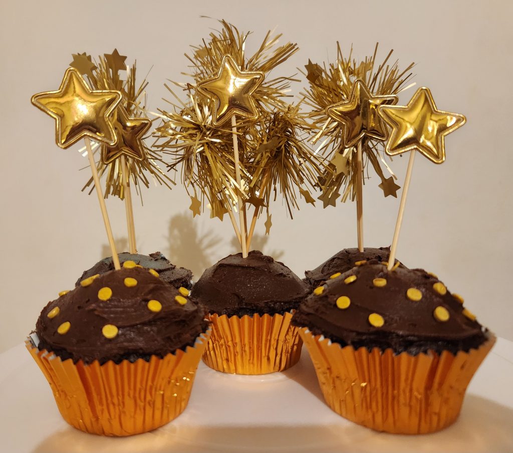 Chocolate cupcakes with golden firework cupcake toppers and golden star cupcake toppers
