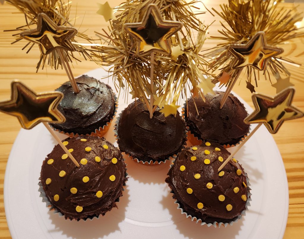 Chocolate cupcakes with golden firework cupcake toppers and golden star cupcake toppers